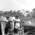 Me, Gerald Durrell and local hunters holding eggs of an African python. The female python, brooding its eggs, had been discovered by the hunters beneath the rocky outcrop behind us and they had removed the eggs before we reached the site.