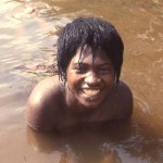 This young woman was washing clothes in the Cross River, Mamfe, Cameroon. April 1966.