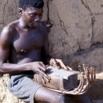 I encountered this man during a 2-hour trek from Mamfe to Eshobi in Cameroon, an area of quite remote rain forest. The instrument he was playing produced some beautiful sounds. April 1966.