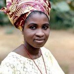 A professional Yoruba woman dressed in a typical Yoruba outfit. The predominant ethnic group of the Ibadan area is Yoruba. University of Ibadan, 1970. 