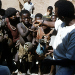 Small animals were called ‘beef’ in the local pidgin English. Here people on the steps of the rest house are being paid for the animals they had brought to us for sale.