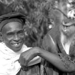 This man brought the mona monkey for sale to the Zoological Garden, University of Ibadan. The monkey had been raised by its owner from a youngster and was completely tame. 1965.