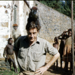Durrell with a patas monkey (Erythrocebus patas) and cherry-crowned mangabey (Cercocebus torquatus).